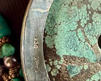 Multi-strand necklace with turquoise and silver beads featuring a large sterling silver pendant with intricate turquoise inlay and decorative elements, including hanging charms. Marked ‘925’ for sterling silver purity. This necklace measures, 19.5” and has a total approx. weight of 205.91 grams.