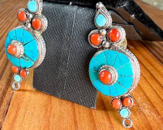 Silver earrings featuring circular design elements inlaid with turquoise and coral stones. The earrings have a post-back fastening with yellow rubber backs. Each features intricate detailing with multiple stone accents. Total approx. weight of 14.51 grams.