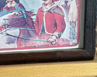 Framed posters advertising the Buffalo Ranch Real Wild West show. Printed by Riverside Print Co., Chicago, these posters feature vibrant depictions of cowboys, Native Americans, and historical scenes. The frames show some age-related wear, and the paper backing is partially torn, exposing an art gallery label from Hulmeville, Pennsylvania. One of them is protected by glass and the other is not. Each one measures in frame, 37” H x 14.5” W.