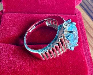 This lot features a 14k gold ring with a quartz center stone surrounded by four genuine diamonds. This ring comes in a size 6.5 with a total approx. weight of 7.71 grams.