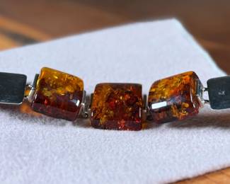 This lot features a stunning sterling silver & baltic amber bracelet that measures, 7” with a total approx. weight of 61.80 grams.