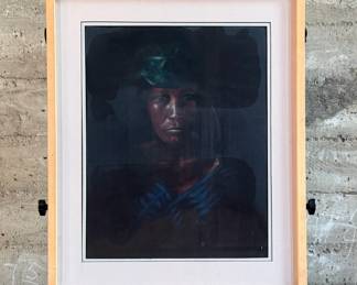 Framed portrait of a woman wearing a green headdress, depicted in a dark tonal palette. The artwork is presented in a wooden frame with white matting. The backing paper is torn, showing wear. Measures in frame, 28” H x 23” W.