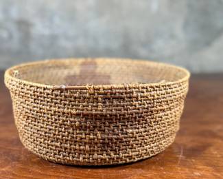 This lot features a Papago squash blossom basket from the early 20th century. Measures, 3.5” H x 9.25” W x 9.25” D.