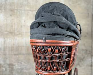 This lot features a beautiful antique Victorian-style doll carriage made from wicker, wood, and metal. This piece measures, 17.5” H x 19” W x 7” D.