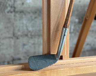 A vintage Frank Bryan Special Mashie golf club featuring a steel head and a wooden shaft. The head is marked with branding and includes the inscription ‘Special Mashie.’ The club has a textured steel clubface and a leather-wrapped grip, showing signs of wear consistent with use and age.