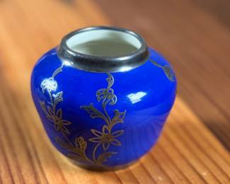Johann Haviland Bavaria porcelain vase featuring a cobalt blue glaze with gilt floral design and sterling silver accents/rim. Bottom stamp reads “Johann Haviland Bavaria.” Measures 2” H, suitable as a small decorative piece or bud vase. Good condition with no visible cracks or chips.