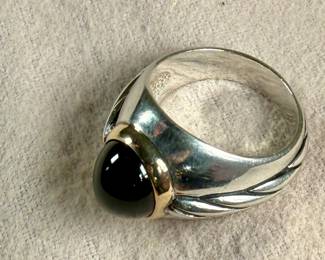 This lot features a ring made from 14k gold and sterling silver with an onyx center stone. This ring comes in a size 9.5 with a total approx. weight of 13.61 grams.