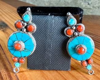 Silver earrings featuring circular design elements inlaid with turquoise and coral stones. The earrings have a post-back fastening with yellow rubber backs. Each features intricate detailing with multiple stone accents. Total approx. weight of 14.51 grams.