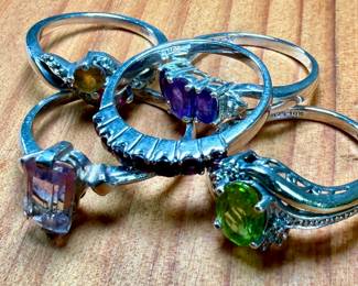 This lot features a collection of five (5) sterling silver rings with various stones. One of the rings is also marked 10k. Total approx. weight of 12.30 grams with ring sizes including 6, 6.5, 7, 7.5, & 8.