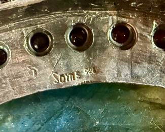 Sterling silver statement necklace featuring an intricate design with various gemstones. The hallmark ‘925’ is stamped on the reverse side, affirming its sterling silver composition. The piece includes multiple strands and pendants accented with gemstones. In good condition and designed with a secure clasp for wearability. This necklace measures, 18” with a total approx. weight of 356.22 grams.