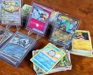 This lot features a large collection of Pokemon cards including both English & Japanese. Many holos and a good amount sleeved for protection.