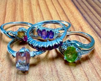 This lot features a collection of five (5) sterling silver rings with various stones. One of the rings is also marked 10k. Total approx. weight of 12.30 grams with ring sizes including 6, 6.5, 7, 7.5, & 8.