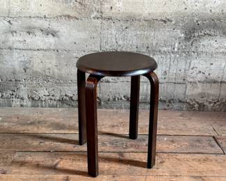 This lot features a modern wood stool in the style of the iconic Artek Stool in very good condition. This piece measures, 17.5” H x 15” W x 15” D.