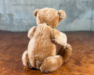 Steiff original teddy bear featuring brown mohair fur and a classic black stitched nose. Retains the trademark Steiff tag in the ear and button. In good condition with visible iconic craftsmanship.