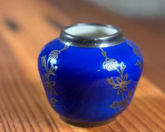 Johann Haviland Bavaria porcelain vase featuring a cobalt blue glaze with gilt floral design and sterling silver accents/rim. Bottom stamp reads “Johann Haviland Bavaria.” Measures 2” H, suitable as a small decorative piece or bud vase. Good condition with no visible cracks or chips.
