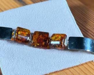 This lot features a stunning sterling silver & baltic amber bracelet that measures, 7” with a total approx. weight of 61.80 grams.
