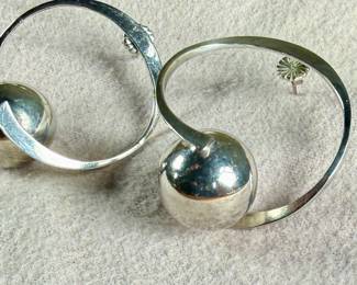 Sterling silver earrings designed in a modernist style, featuring circular hoops with a spherical accent. Marked ‘Mexico 925’, indicating its sterling silver composition. These earrings are designed with posts and butterfly back closures for secure wearing. Total approx. weight of 17.06 grams.