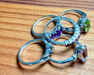 This lot features a collection of five (5) sterling silver rings with various stones. One of the rings is also marked 10k. Total approx. weight of 12.30 grams with ring sizes including 6, 6.5, 7, 7.5, & 8.