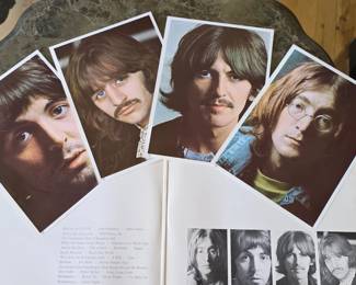 Beatles album with photos and poster with record.