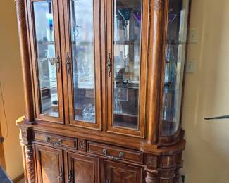Beautiful carved wood lighted cabinet.