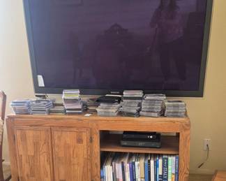 TV, large selection of CDs, VHS tapes and cassette tapes in tv cabinet.
