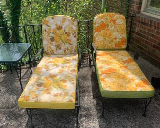 Iron chaise lounges with colorful Mid-Century yellow cushions