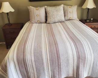 Queen bed and bedding shown w 2 NS
