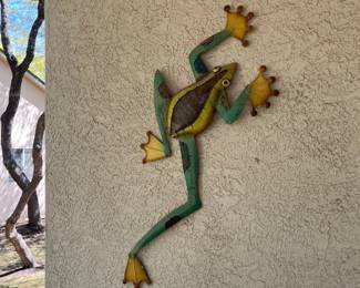 Another metal frog climbing the walls.