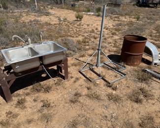 Double stainless sink, metal barrel, metal thingy that might be used for horses IDUNNO