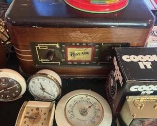 Vintage clocks and Trav-ler wooden tabletop radio.