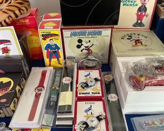 Collection of Disney character watches and toys.