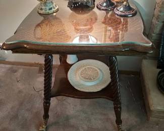Antique Victorian-style parlor table with square top, ball and claw feet.