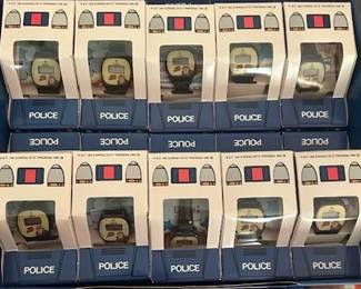 Dick Tracy digital watches manufactured by Omni housed in a police car carboard box.