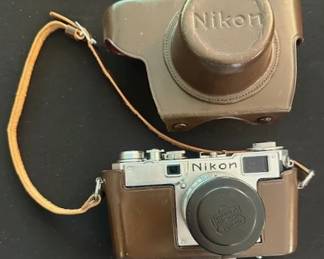 Vintage Nikon S2 35mm rangefinder camera with brown leather case.