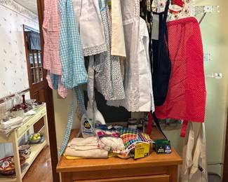 Vintage Kitchen Aprons located in laundry room . Most are handmade