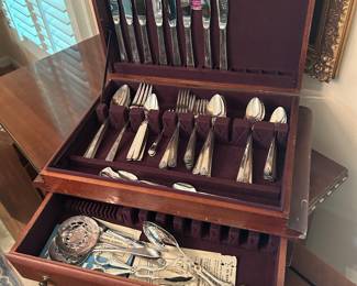 Sliver plated flatware set with case located in dining room 