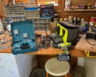 Various cordless drills with batteries and chargers