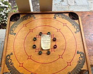 Carrom table game with directions and board pieces 