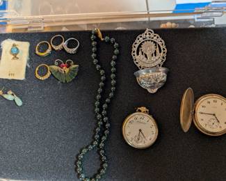 Gold items  to the left of necklace. ( ask Cashier) 