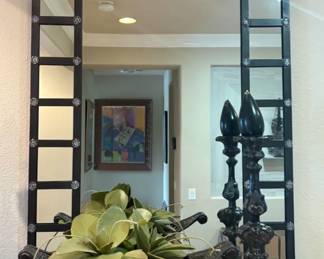 Black Metal Grid Wall Mirror Large statement wall mirror with a bold black metal grid frame and decorative rosette hardware. Approximately 4–5 ft tall. Perfect for an entryway or living room.