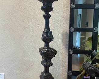 Baroque Candlestick Pair Matching pair of tall baroque-style candlesticks in a dark finish with decorative carved detailing. Sold as a pair.
