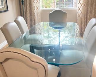 Glass Top Dining Table Elegant dining table with a thick glass top and dark sculptural base. Glass in excellent condition. Pairs with the chairs listed separately.