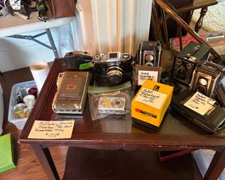 Rolling wooden cart with vintage cameras