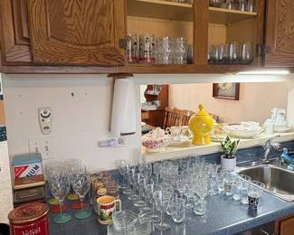 Assorted Glassware, Collectible Tins, and Smurf Mug