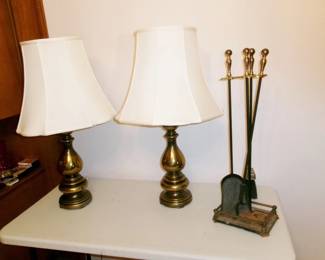 pair of brass lamps and fireplace utensils