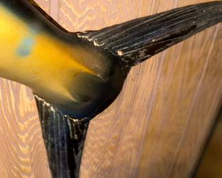 Hey, if you were pinned to the wall for 30 years your tail fins would be falling off too!