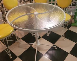 A amaller wrought-iron glass top table