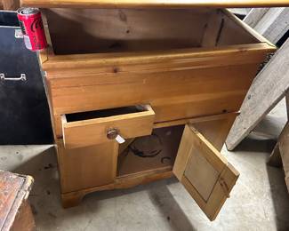 Blanket chest with lid, drawer and door open.
