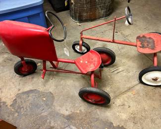 BMC Jr. pedal tractor on the left and a 3 wheel trike on the right.