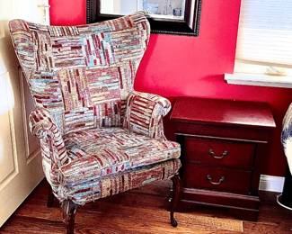 A Corner Of Home Goods  W/ An Traditional Pattern Style Wing Back Chair